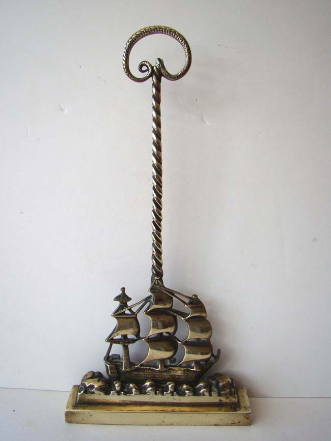 An Antique Victorian brass doorstop in the form of a ship with serpent handle circa 1850